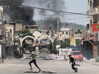 People run during the Isreal operation in Jenin in the West Bank which used drone strikes.