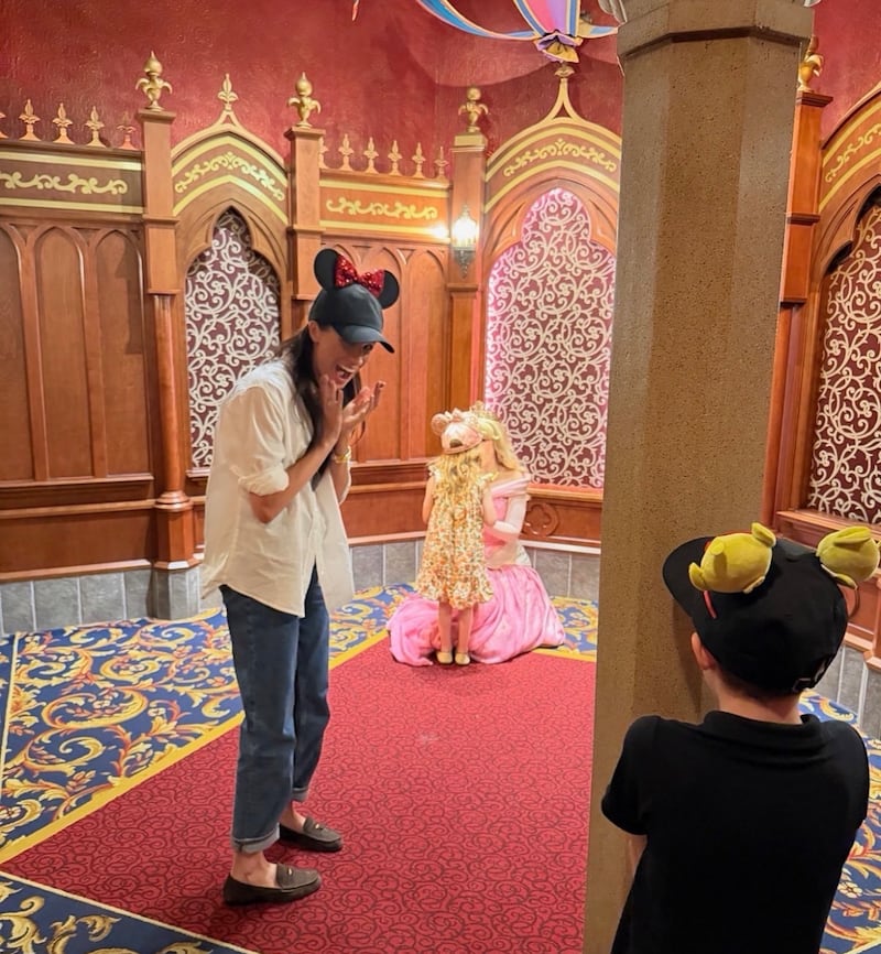 Princess Lillibet is pictured hugging Aurora in Sleeping bueaty castle in the May 11 Instagram post at Disneyland.
