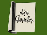 Photo illustration of a dripping Los Angeles Magazine logo on the inside page of a magazine