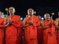 Thai Buddhist monks gather and hold lotus flowers, candles, and joss sticks as they circulate in prayer around Wat Benchamabopitr, or The Marble Temple, to celebrate Visakha Bucha Day in Bangkok, Thailand, on May 11, 2025. Visakha Bucha Day, on the full-moon day of the sixth lunar month, is an annual celebration of Buddha's birth, enlightenment, and death. (Photo by Anusak Laowilas/NurPhoto via Getty Images)