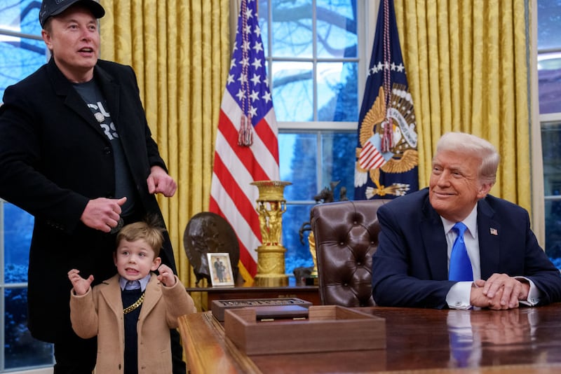 Tesla and SpaceX CEO Elon Musk, joined by his son X Musk, stands next to U.S. President Donald Trump as he speaks during an executive order signing in the Oval Office at the White House on February 11, 2025 in Washington, DC.