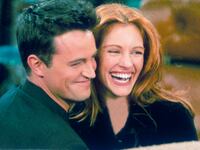 Matthew Perry and Julia Roberts hug on the set of "Friends"