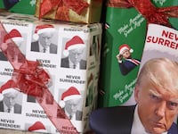 WATERLOO, IOWA - DECEMBER 19: Gifts wrapped in Christmas wrapping paper featuring the likeness of Republican presidential candidate former U.S. President Donald Trump sit on the stage during a rally hosted by the former president on December 19, 2023 in Waterloo, Iowa. Iowa Republicans will be the first to select their party's nomination for the 2024 presidential race, when they go to caucus on January 15, 2024. (Photo by Scott Olson/Getty Images)