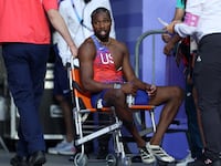 Bronze medalist Noah Lyles of Team United States is taken off from the track with a wheelchair