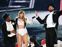 Taylor Swift and Travis Kelce on stage during her Eras Tour stop in London.