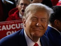 Former U.S. President and Republican presidential candidate Donald Trump rallies with supporters at a “commit to caucus” event at a whiskey bar in Ankeny, Iowa.