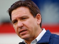 Florida Gov. Ron DeSantis speaks on stage at an event.