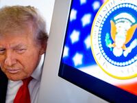 President Donald Trump takes a question from a reporter aboard Air Force One on August 15, 2025, in flight.