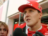 Germany's Michael Schumacher talks to reporters after finishing the first free practice session October 10 for Sunday's Formula One Japanese Grand Prix at Suzuka Circuit.