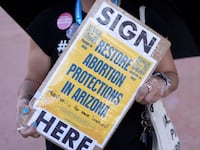 A pro-abortion protester holding a sign