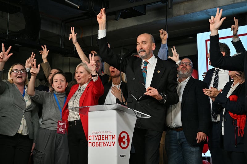 Radomir Saicic, a chemistry professor and candidate on the student-backed electoral list (C), celebrates the Students' List victory in the Serbian parliamentary elections on stage with other candidates and supporters at their headquarters in Belgrade on October 25, 2026. The vote saw the hightest voter turnout in over 30 years according to the election commission and is the culmination of nearly two years of student-led protests sparked by the 2024 collapse of a canopy at Novi Sad railway station that killed 16 people, a tragedy widely blamed on corruption. (Photo by Andrej ISAKOVIC / AFP via Getty Images)