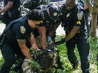 Police officers arrest a demonstrator during a pro-Palestinian protest against the war in Gaza at Emory University on April 25, 2024, in Atlanta, Georgia.