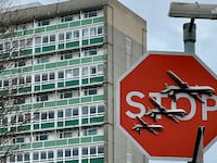 Banksy artwork depicting drones covers a stop sign in London