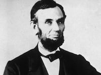 The 16th American president, Abraham Lincoln (1809 - 1865), sitting and leafing through documents, Washington, D.C.