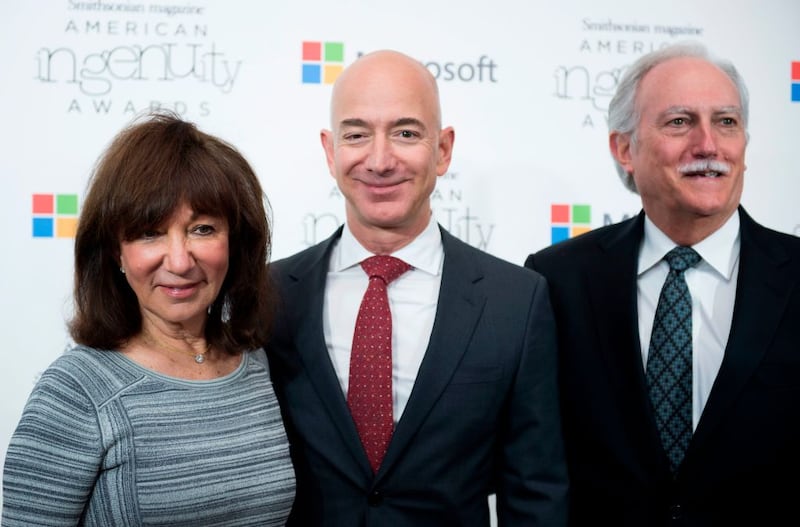 Amazon CEO Jeff Bezos poses on the red carpet with his parents Mike and Jackie, for the Smithsonian Magazine's 2016 American Ingenuity Awards, honoring groundbreaking individuals in several categories, at the National Portrait Gallery on December 8, 2016 in Washington, DC. - Amazon CEO Jeff Bezos received the Technology award for his historic achievement in aviation and space exploration. (Photo by MOLLY RILEY / AFP) (Photo by MOLLY RILEY/AFP via Getty Images)