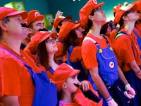 Cosplayers dressed as Mario