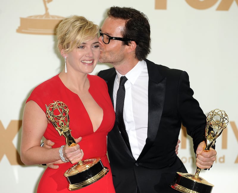 Kate Winslet and Guy Pearce pose backstage at the 63rd Primetime Emmy Awards.