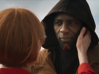 A woman holds a man's face.