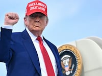 US President Donald Trump pumps his fist as he boards Air Force One at Morristown Municipal Airport in Morristown, New Jersey, on June 21, 2025 as he returns to the White House from his golf club in Bedminster, New Jersey. (Photo by Mandel NGAN / AFP) (Photo by MANDEL NGAN/AFP via Getty Images)