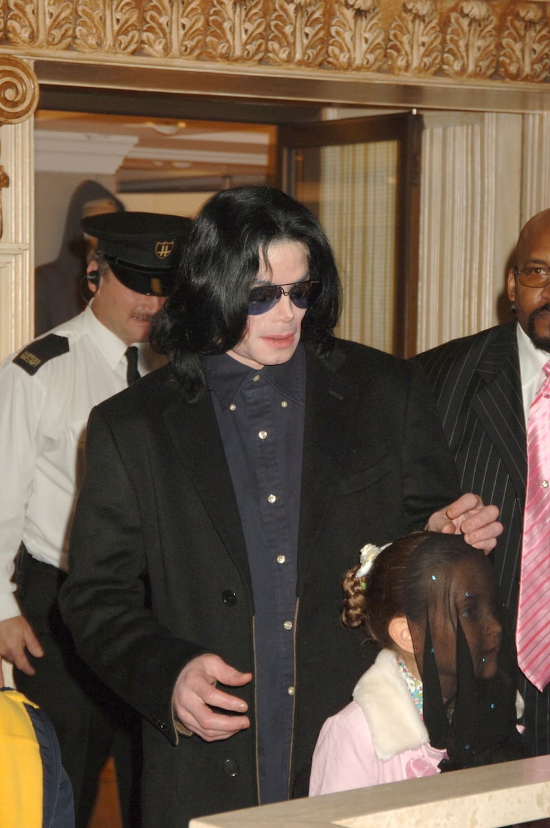 Michael Jackson walks with his daughter, Paris