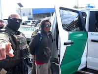 A person is detained by US Customs and Border Patrol (CBP) agents near a Lowe's hardware store in New Orleans, Louisiana