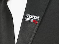 A photo illustration showing the Time’s Up movement pin, with the Up flipped upside down.