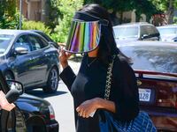 articles/2014/05/05/donald-sterling-s-former-mistress-makes-the-paparazzi-shield-chic-cara-delevingne-has-self-grooming-eyebrows/140505-stiviano-fashion-cheat_wl57wj