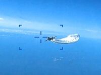 A Russian Su-27 military aircraft dumps fuel while flying toward a U.S. Air Force MQ-9 Reaper drone over the Black Sea, March 14, 2023.