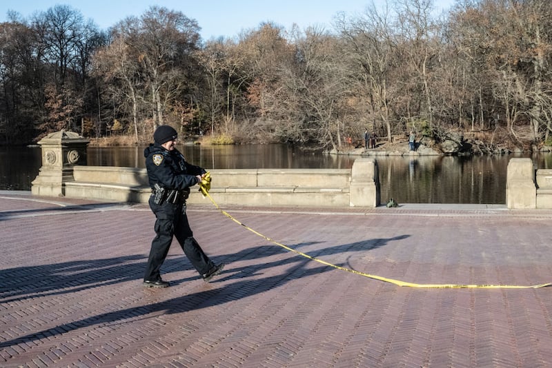 Police patrol near the pond next to Bethesda Fountain in Central Park, part of an investigation into the killing of UnitedHealthcare CEO Brian Thompson last week.