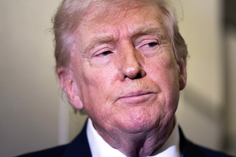 President Donald Trump speaks to members of the media aboard Air Force One while flying from Palm Beach International Airport on February 16, 2026 en route to Washington, DC.