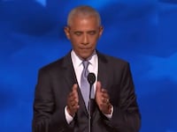 Obama making a small gesture with his hands.