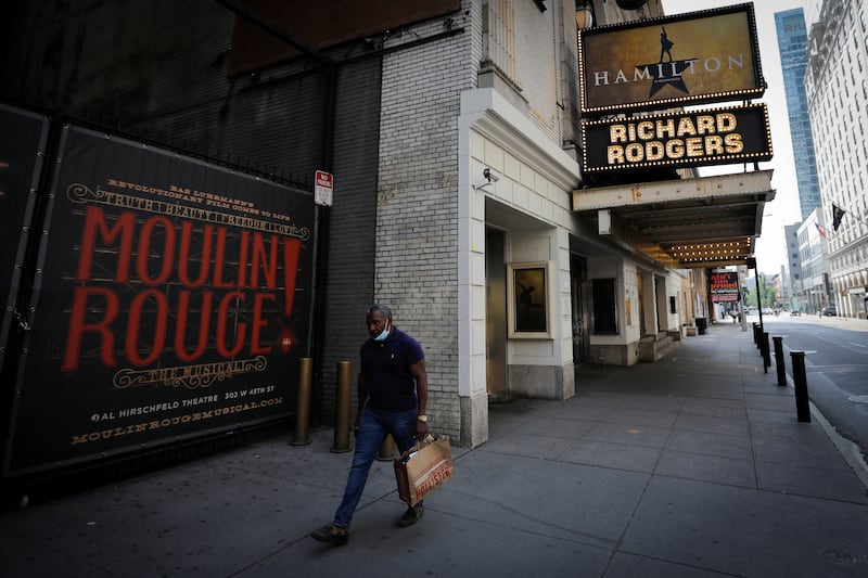 A man walks past the shuttered Richard Rodgers Theatre, home of the popular musical "Hamilton" after industry group the Broadway League said Broadway theaters will remain closed through January 3, 2021, in New York, U.S., July 2, 2020.
