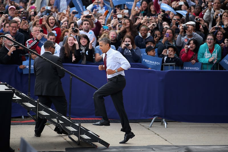 NASHUA, NH - OCTOBER 27: U.S. President Barack Obama runs up stairs to the stage during a campaign rally at Elm Street Middle School October 27, 2012 in Nashua, New Hampshire. With ten days before the presidential election, Obama and his opponent, former Massachusetts Gov. Mitt Romney are criss-crossing the country from one swing state to the next in an attempt to sway voters. (Photo by Chip Somodevilla/Getty Images)
