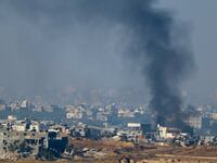 Smoke rises from damaged buildings in Gaza.