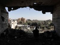 A photograph of a Palestinian citizens inspecting the effects of destruction caused by air strikes on their homes in the Khuza’a area on November 24, 2023 in Khan Yunis, Gaza.