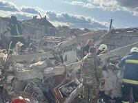 Rescuers work at a site of a Russian military strike, amid Russia's attack on Ukraine, in the village of Hroza, in Kharkiv region,