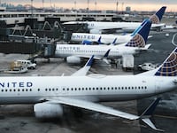 Passengers had to leave a United Airlines plane via slides after black smoke could be seen gushing out of an engine.