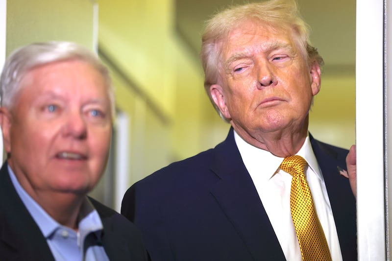 U.S. President Donald Trump (R) and U.S. Sen. Lindsey Graham (R-SC) speak to the media