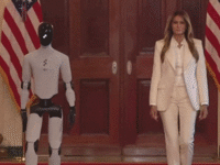 An animated gif of AI-powered robot with first lady Melania Trump to a White House summit on empowering children with educational technology.