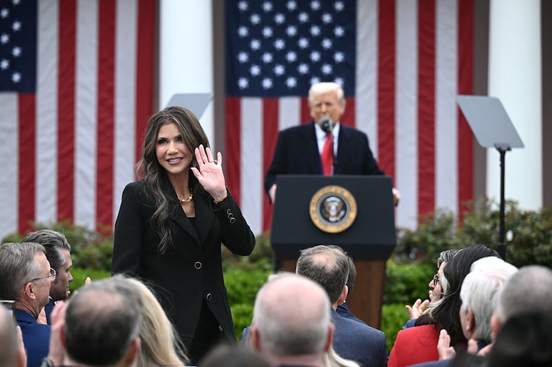 US Secretary of Homeland Security Kristi Noem waves after being acknowledged by US President Donald Trump as he delivers remarks on reciprocal tariffs during an event in the Rose Garden entitled "Make America Wealthy Again" at the White House in Washington, DC, on April 2, 2025. Trump geared up to unveil sweeping new "Liberation Day" tariffs in a move that threatens to ignite a devastating global trade war. Key US trading partners including the European Union and Britain said they were preparing their responses to Trump's escalation, as nervous markets fell in Europe and America. (Photo by Brendan SMIALOWSKI / AFP) (Photo by BRENDAN SMIALOWSKI/AFP via Getty Images)