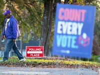 Emory Jones walks past a sign for a polling place in Winston Salem, North Carolina