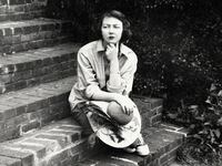 A photograph of Flannery O'Connor sitting on the steps of her home in Milledgeville, Ga. on Sept. 22, 1959.