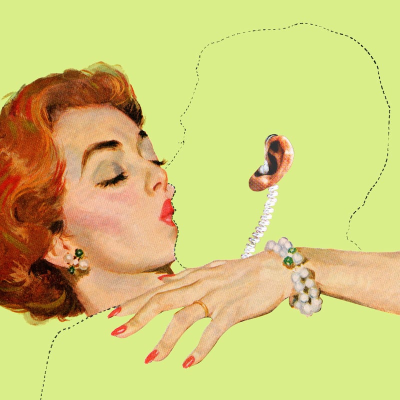 A woman kissing an outlined man with his ear and ear piece showing