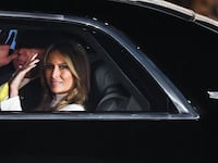 US President Donald Trump and First Lady Melania Trump wave from their car as they leave Palam Air Force Base in New Delhi on February 24, 2020