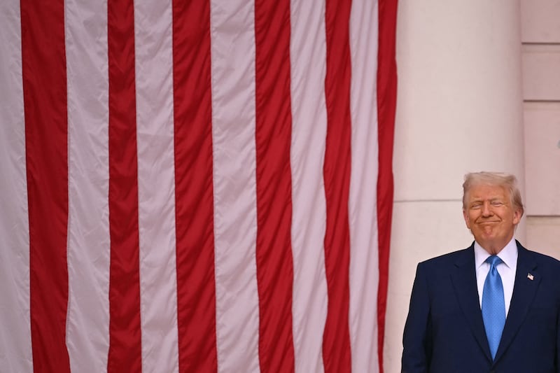 President Donald Trump smiles before speaking at the Tomb of the Unknown Soldier in Arlington National Cemetery in Arlington, Virginia, on Memorial Day, May 26, 2025.