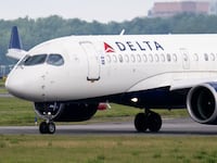 A Delta Air Lines Airbus A220 airplane prepares to takeoff at Ronald Reagan Washington National Airport in Arlington, Virginia, on July 10, 2025. Delta Air Lines stock shares surged more than 11 percent in early trading on Thursday, as the airline reported better-than-expected results. Between April and June, the group posted year-on-year sales of $16.65 billion and net income of $2.13 billion (+63% year-on-year). (Photo by SAUL LOEB / AFP) (Photo by SAUL LOEB/AFP via Getty Images)