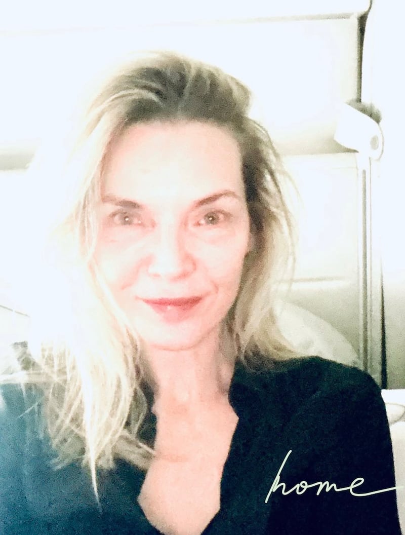 Michelle Pfeiffer smiled makeup-free after her 48-hour trip to Paris.