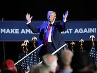 Donald Trump, reacts after his microphone malfunctioned while campaigning in Detroit, Michigan.