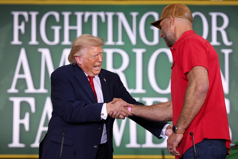 U.S. President Donald Trump shakes hands with Hall of Fame Farms owner Joe Thomas (R) as he arrives to a roundtable on agriculture at Custer Farms on June 05, 2026 in Chippewa Falls, Wisconsin.