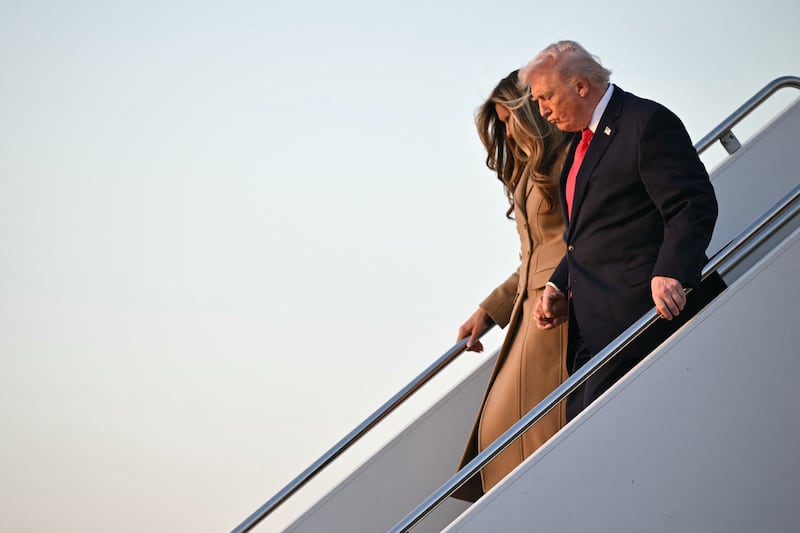 Trump grips the handrail and his wife's hand while descending Air Force One ahead of Valentine's Day weekend. It remains to be seen whether the two have any plans together on the 14th.